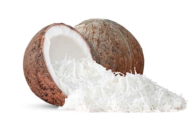 Dessicated coconut and two coconut shells